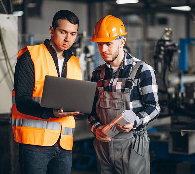 Two men in a manufacturing plant